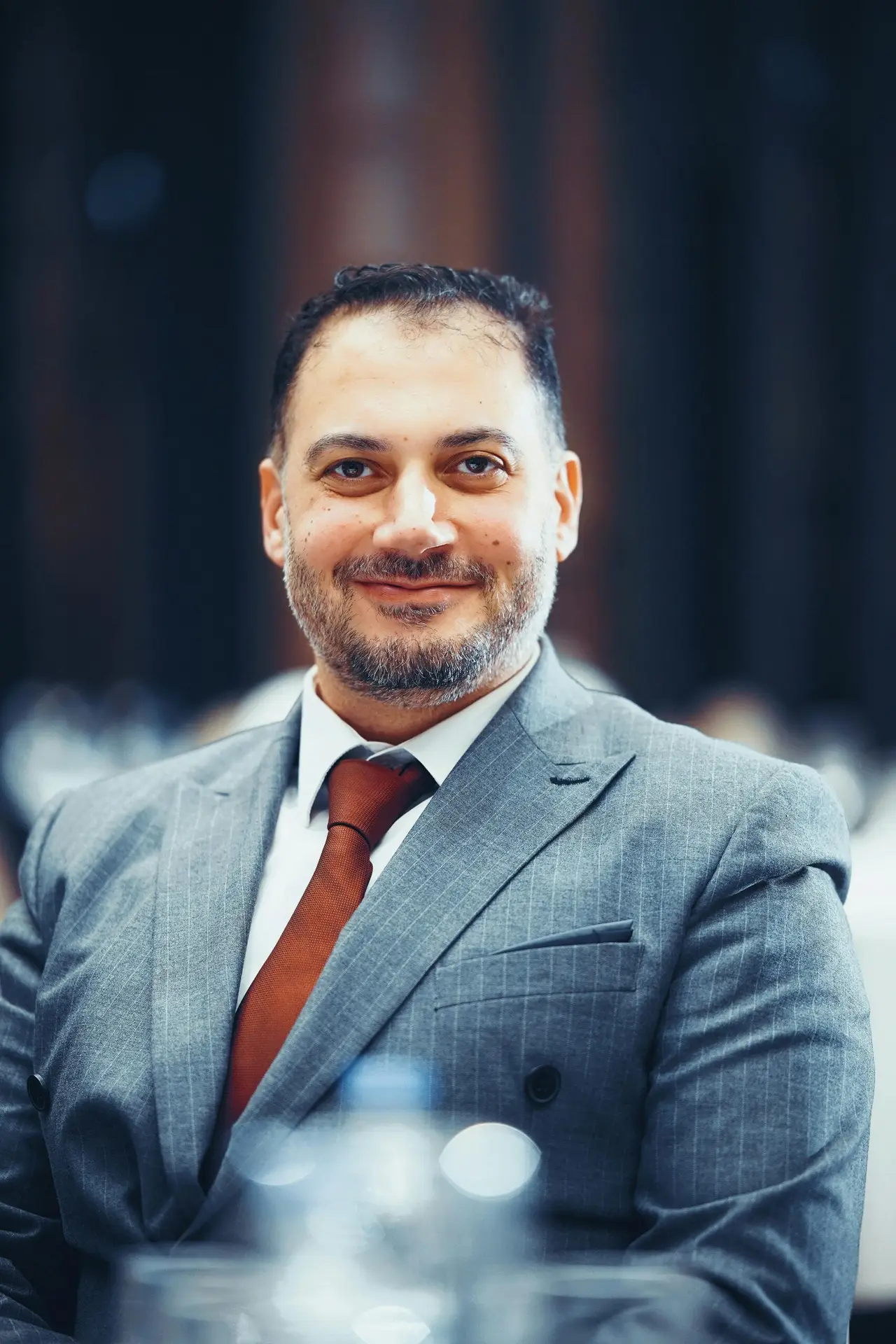Portrait of a confident businessman in a suit, captured in a modern interior setting in Istanbul, Turkey.